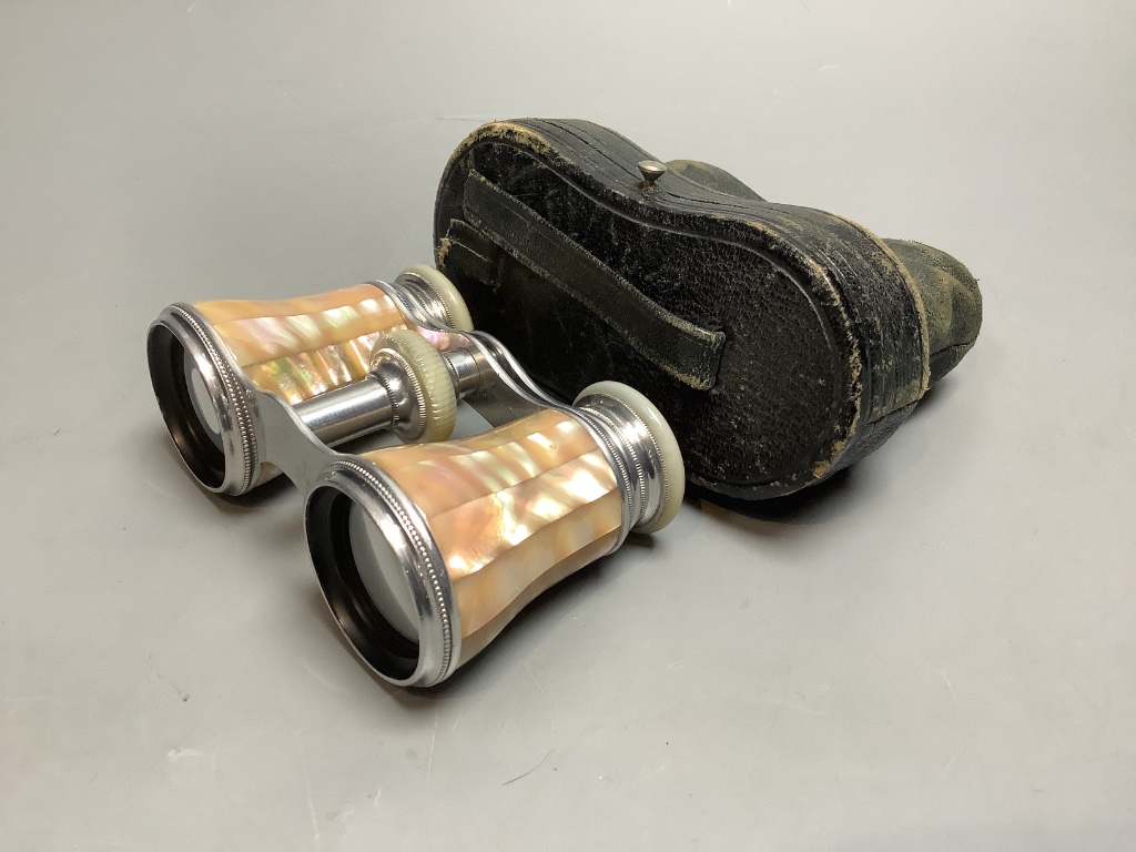 A cased pair of mother of pearl opera glasses, 6cm